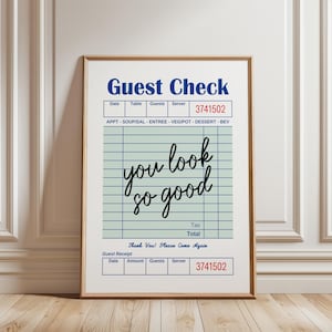 May include: A framed print resembling a restaurant guest check. The top section reads "Guest Check" in blue, with fields for date, table, guests, and server. The text "you look so good" is written in cursive. The bottom section repeats the check details.