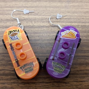 Teenage Mutant Ninja Turtles Donatello and Michelangelo skateboard minifigure earrings.