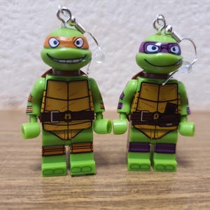 Teenage Mutant Ninja Turtles Donatello and Michelangelo minifigure earrings.