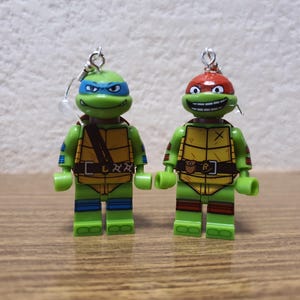 Teenage Mutant Ninja Turtles Raphael and Leonardo minifigure earrings.