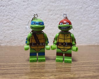 Teenage Mutant Ninja Turtles Raphael and Leonardo minifigure earrings.