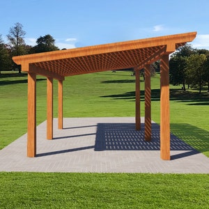 May include: A wooden pergola with a slatted roof and four supporting posts. The pergola is set on a gray patio in a grassy area with trees in the background.