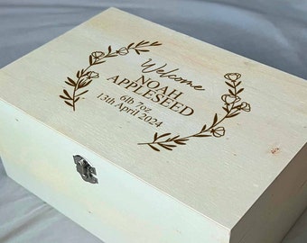 May include: A white wooden keepsake box with a floral design and the text "Welcome Noah Appleseed 6lb 7oz 13th April 2024".