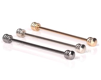 May include: Three tie bars in different finishes: gold, silver, and black. Each tie bar has a cylindrical design with multiple rings.