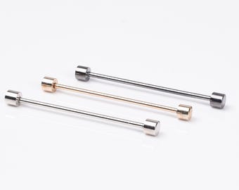 May include: Three tie bars in different finishes: silver, gold, and black. The tie bars are all the same length and have round ends.
