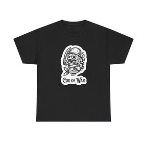 May include: Black t-shirt featuring a white graphic of a fish warrior with a helmet, sword, and a scroll. The text "COD OF WAR" is below the graphic. The shirt is made of a soft, comfortable material.