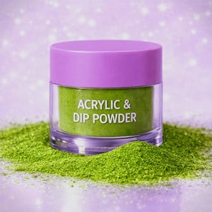 May include: A clear jar with a lavender lid filled with green acrylic and dip powder. The text "ACRYLIC & DIP POWDER" is printed on the jar. The jar sits on a bed of loose green powder against a soft purple background.