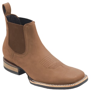 May include: Brown leather ankle boots with a pointed toe and a pull-on design. The boots have a stitched design on the side and a small heel.