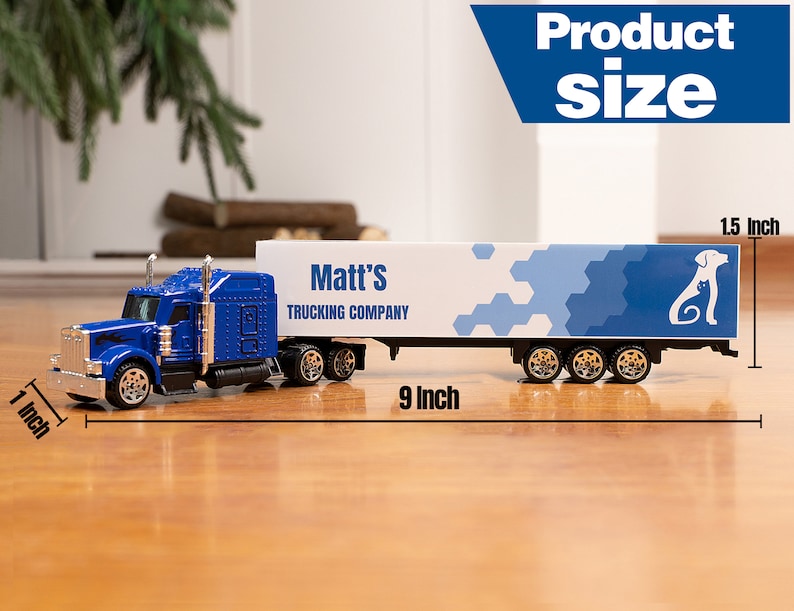 May include: Blue toy semi-truck with a white trailer. The trailer has a blue and white geometric pattern and the text "Matt's Trucking Company". The truck is 23 cm long and 3.8 cm tall.