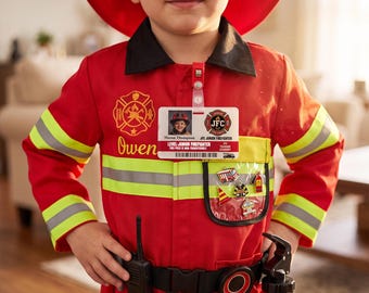 May include: A red firefighter costume jacket with a black collar, yellow reflective stripes, and a red helmet. It features a personalized ID badge with the text Mason Thompson and JFC Junior Firefighter, a black belt, a walkie-talkie, and a water bottle.