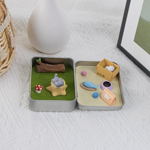 May include: A white ceramic mug with a black handle and the text "But first, coffee" in a handwritten style. The mug is on a white surface. The mug appears to be 4 inches tall.