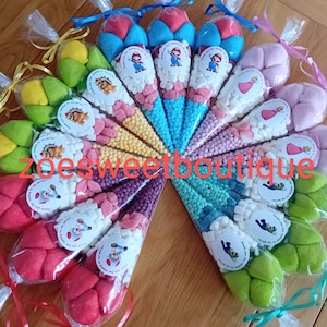 May include: A selection of candy cones, each filled with a variety of sweets and topped with marshmallows. Each cone has a sticker saying "Thank you for coming to my party!" and is tied with a ribbon in various colours.