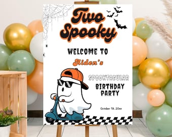 May include: A white sign on an easel with the words "Two Spooky" in orange and black. The sign welcomes guests to Aiden's Spooktacular Birthday Party. A cartoon ghost wearing sunglasses and a hat rides a scooter. Balloons in various colors surround the sign.
