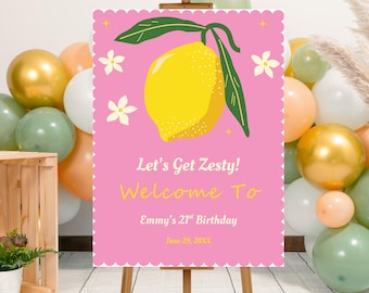 May include: A pink welcome sign with a lemon illustration and the text "Let's Get Zesty! Welcome To Emmy's 21st Birthday June 29, 20XX." The sign is on a wooden easel, surrounded by balloons in various colors.