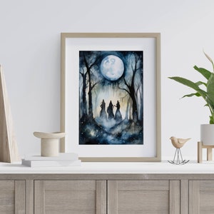 May include: A watercolor painting of three figures in a forest under a full moon. The figures are silhouetted against the moon and the trees. The painting is framed in a light wood frame.