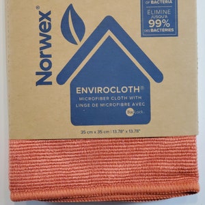 May include: A Norwex Envirocloth microfiber cleaning cloth in a coral color. The cloth is 13.78 inches by 13.78 inches and is made with BacLock technology. The packaging states that the cloth removes up to 99% of bacteria.
