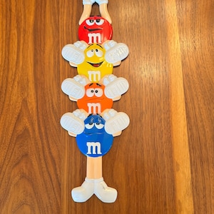 M & Ms backscratcher, collectible candy character, vintage advertisement, approx 15” long, durable plastic, candy lover, MMs nostalgia