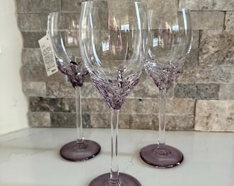 3 Handblown wine glasses by Romanian artist Ion Tamaian. Clear with light purple accents on the base and neck. Approx 10.5” Signed.