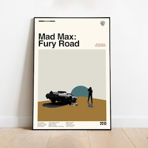May include: A framed poster for the movie "Mad Max: Fury Road" featuring a minimalist design. The poster includes a wrecked car, a silhouetted figure, and the film's title. The color palette consists of beige, brown, and teal.