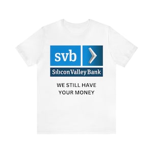 May include: White t-shirt with a blue and gray Silicon Valley Bank logo and the text "We still have your money".