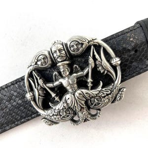 May include: A set of three ceramic mugs with a speckled, matte finish. The mugs are in shades of cream, light gray, and dark gray. Each mug has a simple, minimalist design and a rounded handle.