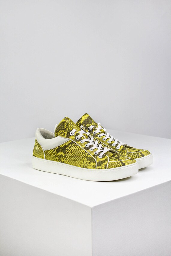 Yellow python sneakers made of genuine python leather. Luxury and exotic footwear. Shoes can be both for men and women.