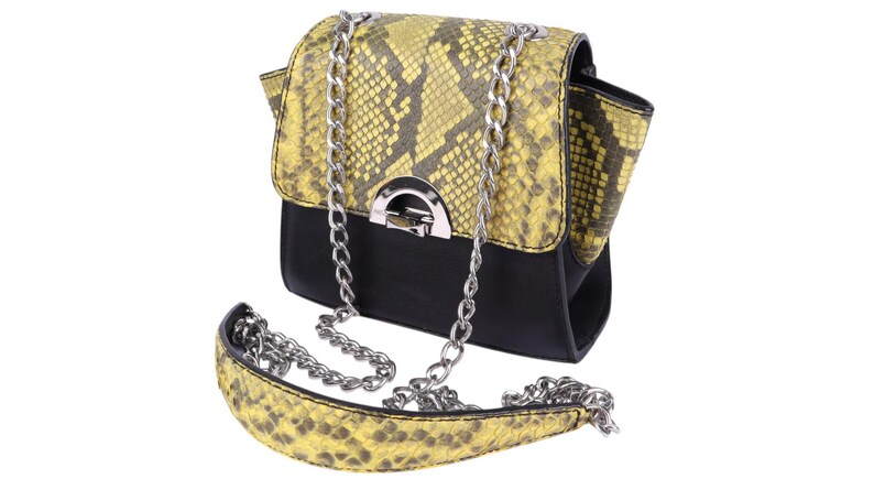 May include: A small, black and yellow snakeskin-patterned handbag with a silver chain strap. The bag has a flap closure with a silver clasp. The shoulder strap is also snakeskin-patterned.