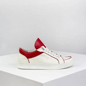 Sneakers made of natural white python with red leather accents