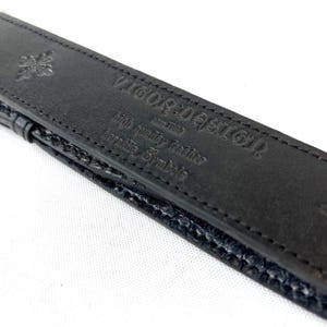 May include: A rustic wooden sign with the text "Welcome to our home" in white lettering. The sign features a distressed finish and a simple, inviting design, perfect for front door decor.