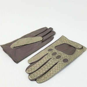 May include: A pair of brown gloves with a snakeskin pattern on the back of the hand and fingers. The gloves are made of a soft material and have a classic design. The gloves are likely for driving or fashion.