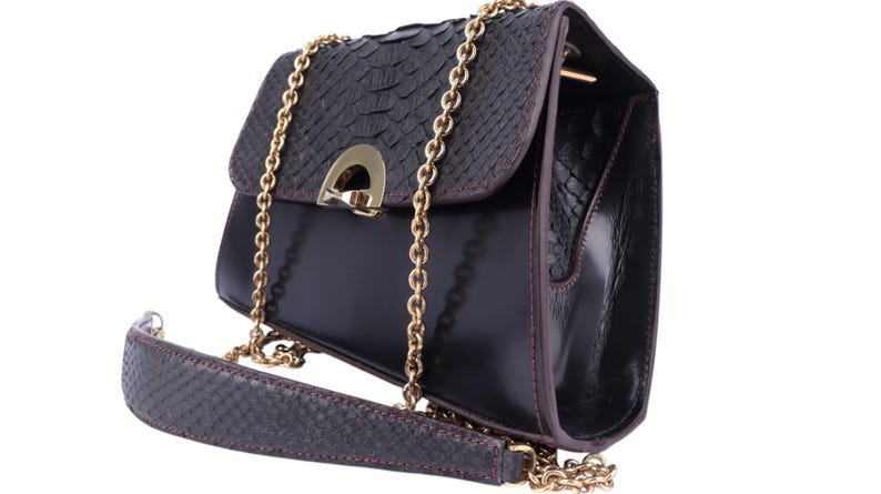 May include: Black leather shoulder bag with a textured flap and gold-tone chain strap. The bag has a rectangular shape with a flap closure and a gold-tone clasp. The strap is a combination of leather and chain.