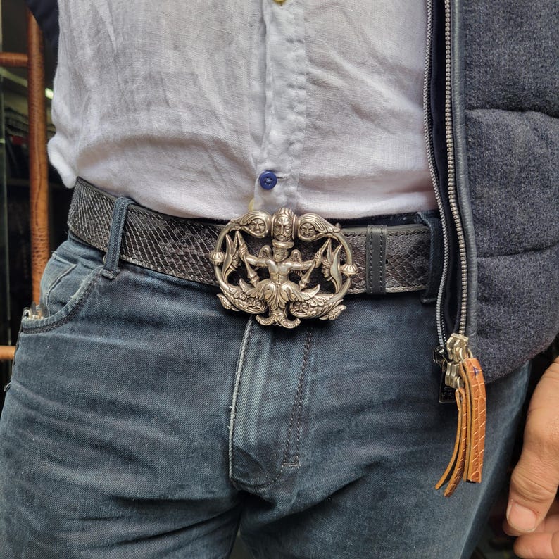 May include: A set of three ceramic mugs with a speckled, matte finish. The mugs are in shades of cream, light gray, and dark gray. Each mug has a simple, minimalist design, perfect for coffee or tea.