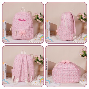 May include: Pink gingham backpack with a bow and the name "Viola" embroidered on the front. The backpack has a front pocket, side pockets, and a top handle. The bag is made of a quilted fabric.
