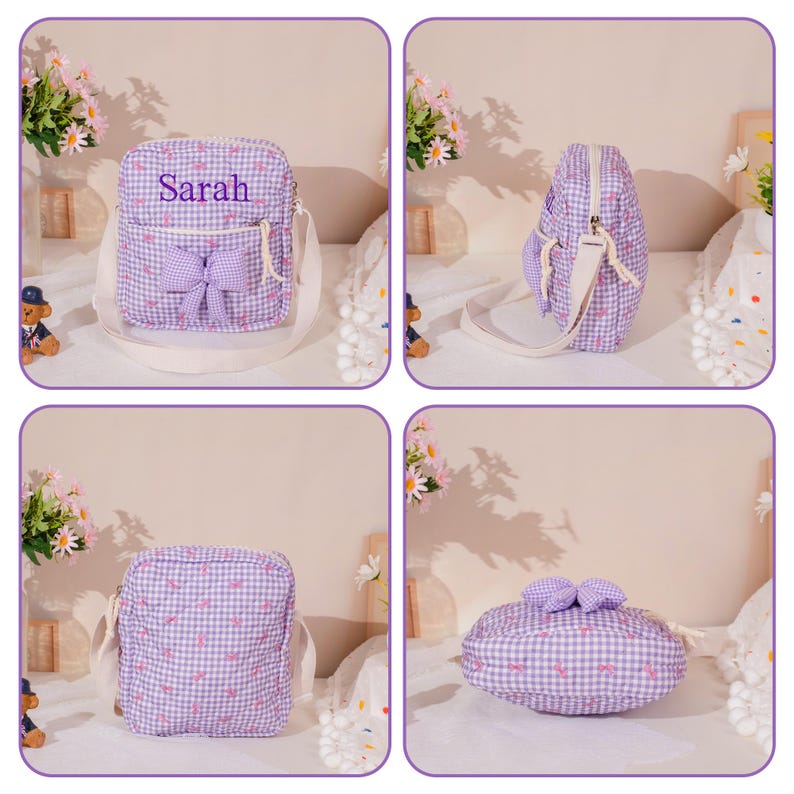 May include: A purple and white gingham crossbody bag with a bow on the front and the name "Sarah" printed on it. The bag has a white strap and a small front pocket. The bag is made of a soft, quilted material.