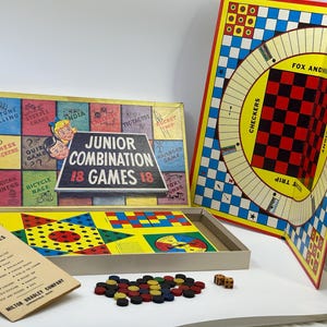 May include: A vintage Junior Combination 18 Games board game box with a colorful illustration of children playing games. The box includes a variety of games, including checkers, tic-tac-toe, and a bicycle race.