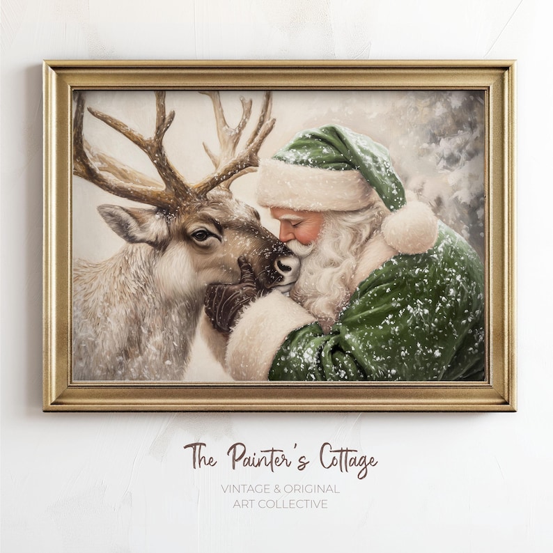 May include: A framed vintage print depicts Santa Claus in a green suit and hat, embracing a reindeer. The artwork has a gold frame and features the text "The Painter's Cottage, Vintage & Original Art Collective."