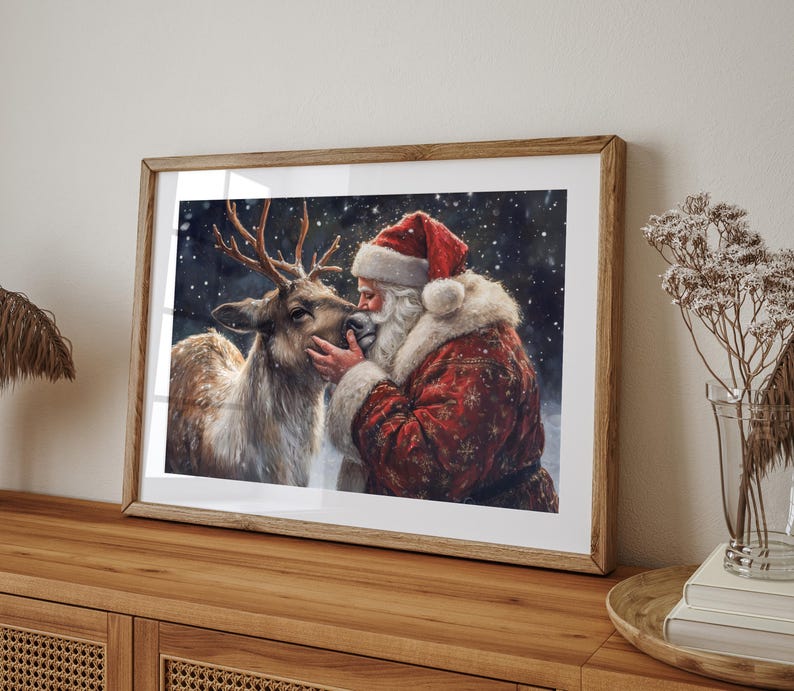 May include: A framed painting of Santa Claus with a white beard and red hat, kissing a reindeer on the nose. The background is a snowy forest scene.