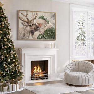 May include: A framed Christmas-themed artwork depicts Santa Claus embracing a reindeer. The artwork hangs above a white fireplace with a burning fire. A decorated Christmas tree and a cozy armchair complete the festive scene.