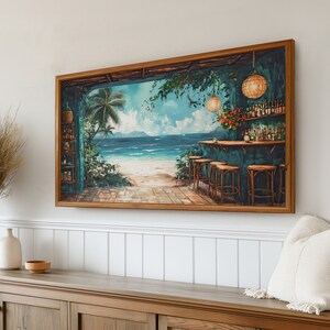 May include: A framed painting depicting a tropical bar scene with a view of a beach and ocean. The bar has a turquoise countertop and wooden stools. There are palm trees and hanging lights in the foreground.