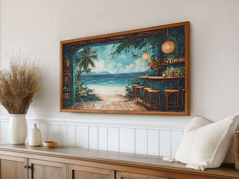 May include: A framed painting depicting a tropical bar scene with a view of a beach and ocean. The bar has a turquoise countertop and wooden stools. There are palm trees and hanging lights in the foreground.