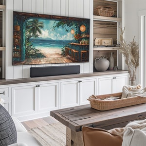 May include: A living room with a white and wood entertainment unit featuring a flat screen TV displaying a tropical beach scene. The entertainment unit has a soundbar and white cabinets. A wooden coffee table with a woven basket and a throw blanket sits in front of the entertainment unit.