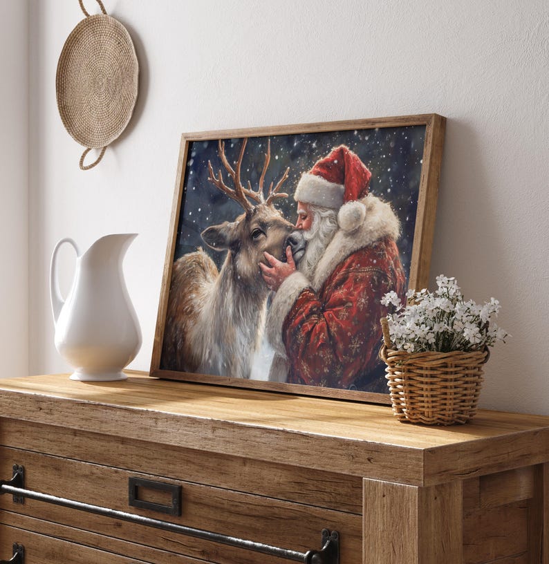 May include: A framed painting of Santa Claus with a reindeer. Santa is wearing a red suit with white trim and a red hat. The reindeer is brown with antlers. The background is a snowy night scene.