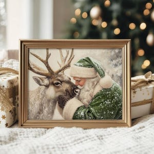May include: A framed Christmas print featuring Santa Claus in a green suit and hat, embracing a reindeer. The artwork has a vintage style with a gold frame. The background includes a Christmas tree and wrapped gifts.