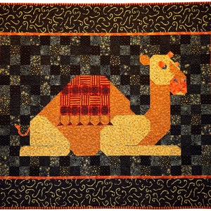 May include: A patchwork quilt featuring a camel with a red and orange patterned saddle. The camel is sitting on a black and gold checkered background with a black border.