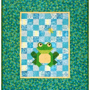 May include: A green frog applique on a blue and white checkered fabric background. The fabric is surrounded by a green leafy border.