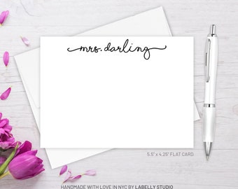 May include: A white flat card with the text "mrs. darling" in black cursive script. The card measures 5.5 inches by 4.25 inches.
