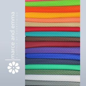 May include: A stack of 20 different colored mesh fabrics. The fabrics are arranged in a rainbow pattern, with the lightest colors at the top and the darkest colors at the bottom.