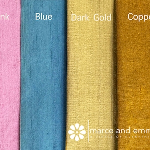 May include: Close-up of four fabric swatches in pink, blue, dark gold, and copper. Each swatch has a different color and texture. The word "Pink" is written above the pink swatch, "Blue" above the blue swatch, "Dark Gold" above the dark gold swatch, and "Copper" above the copper swatch. The brand name "marce and emma" is also visible.