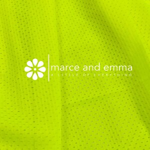 May include: A bright yellow mesh fabric with a white logo that reads "marce and emma a little of everything".
