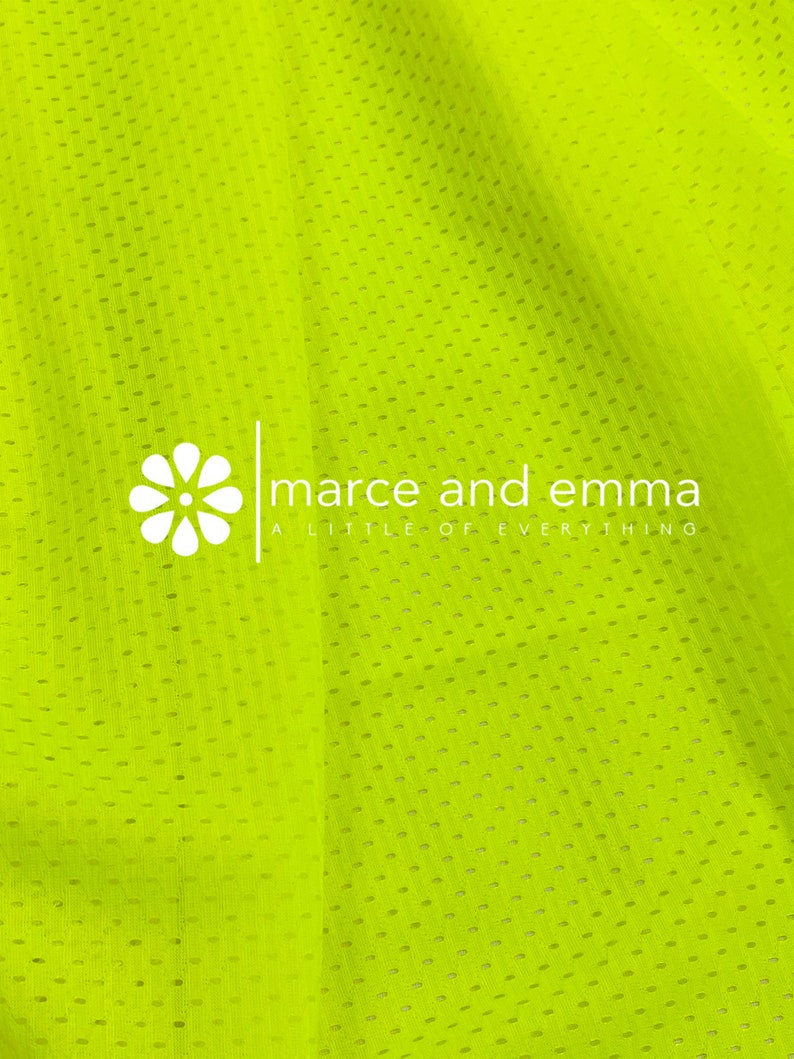 May include: A bright yellow mesh fabric with a white logo that reads "marce and emma a little of everything".
